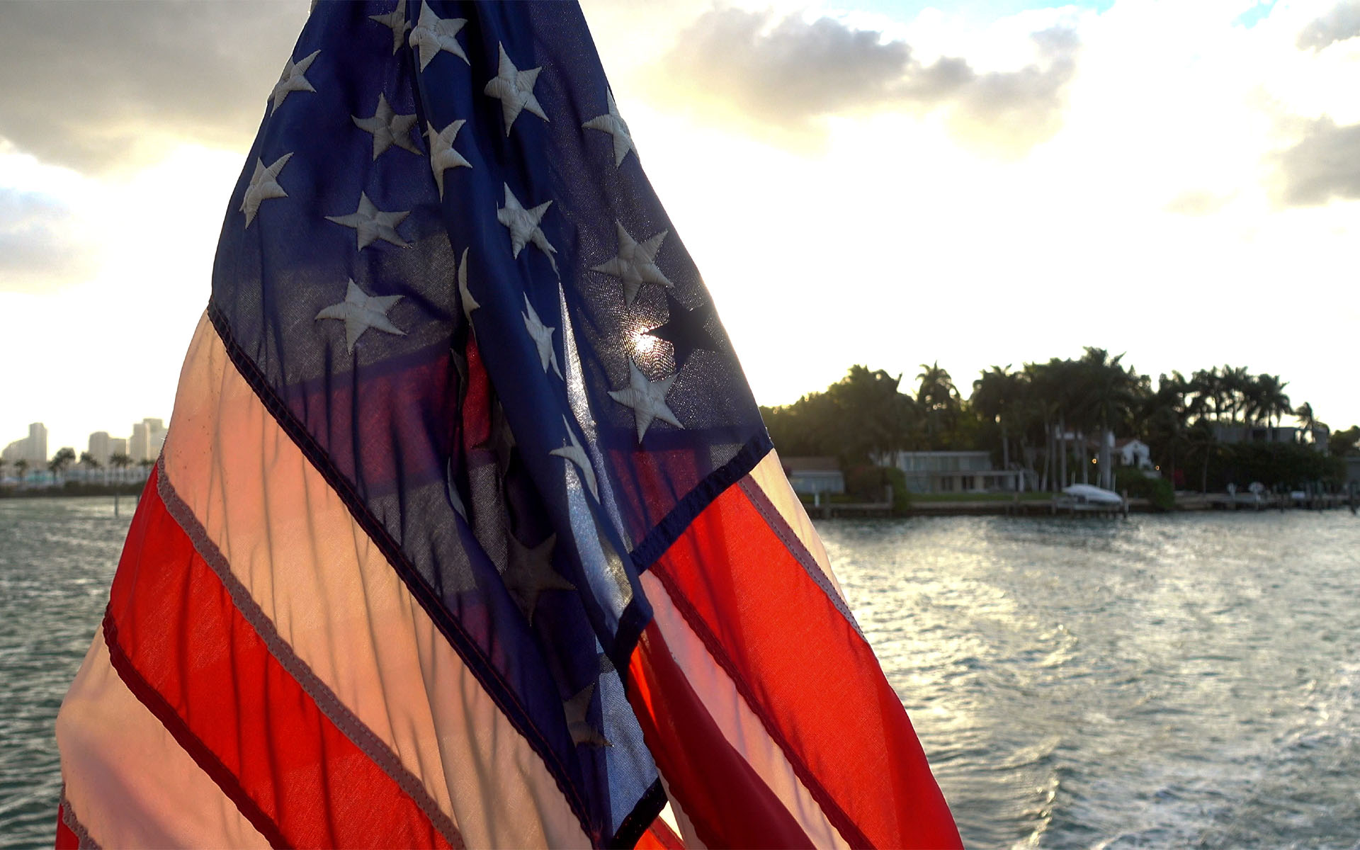 Homepage - View of the American Flag on a Boat That is Sailing on the Ocean in Florida